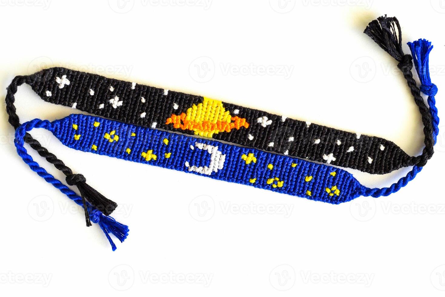 Two woven DIY friendship bracelets with alpha patterns Space photo
