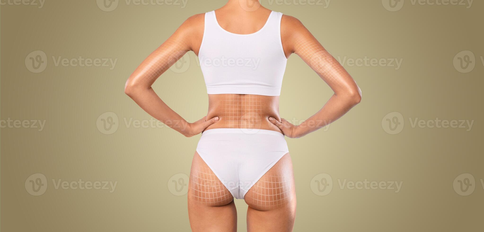 A woman stands confidently, highlighting her curves while engaging in body sculpting and contouring practices. The focus is on her back, showcasing skin care and pampering in action. photo