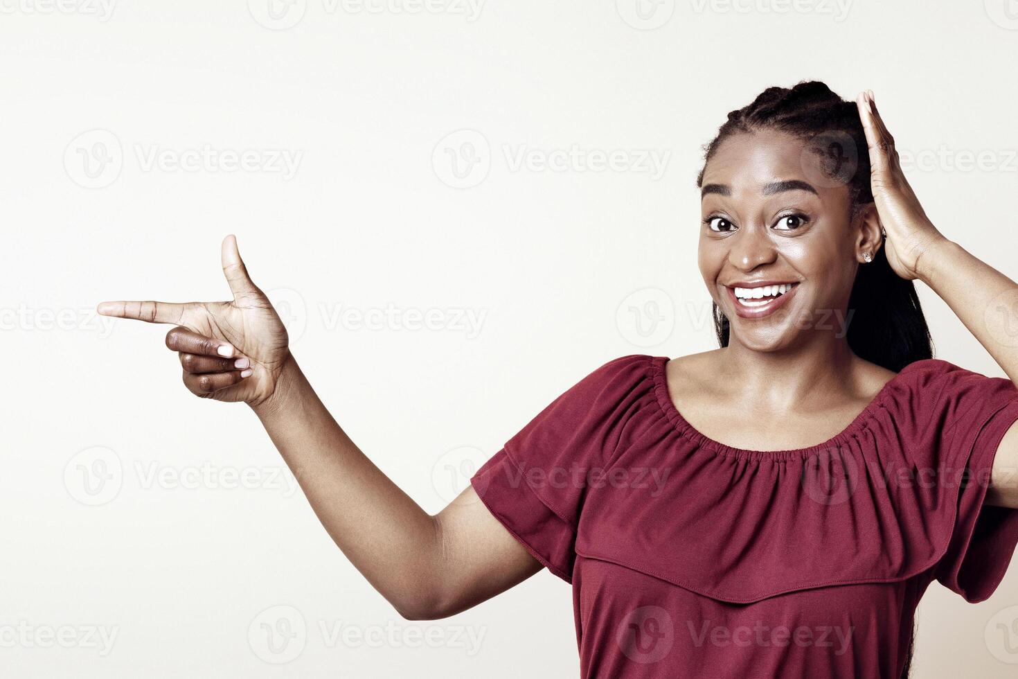 Excited african american millennial woman in casual pointing at copy space for advertisement and touching her head, showing amazing deal or shocking news, beige studio background, panorama photo