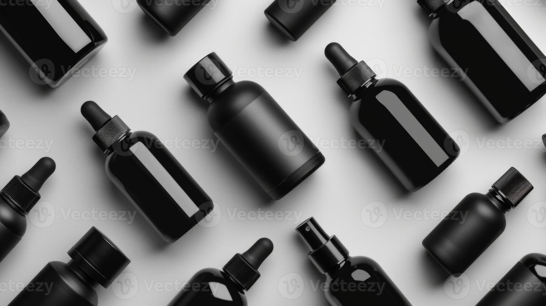 An assortment of black glass bottles featuring various shapes and sizes is displayed on a light background, highlighting their use for essential oils, serums, or skincare products. photo