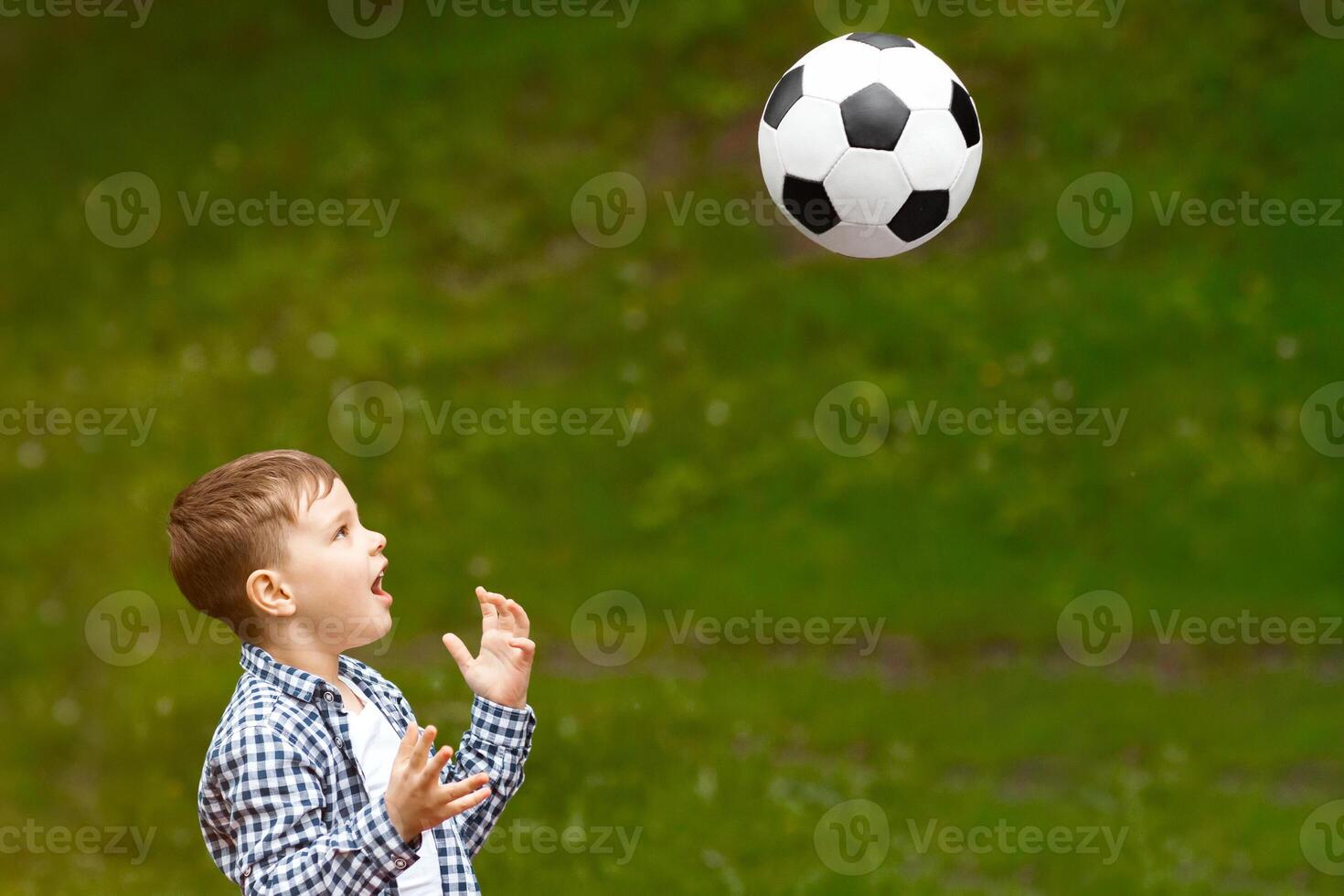Summertime family activities. Adorable boy with his father playing soccer together on picnic in forest photo