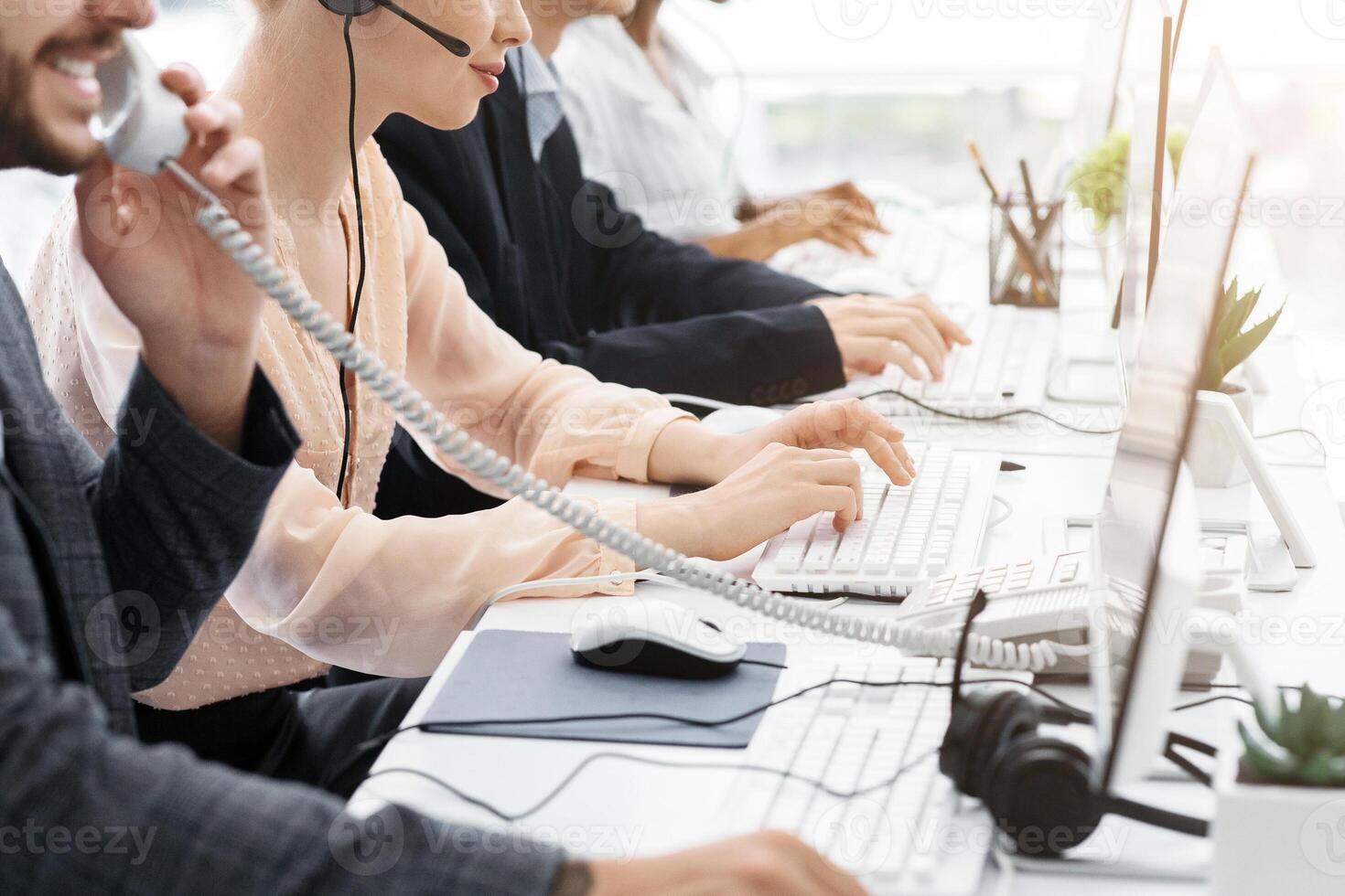 Closeup view of customer support operators working at call centre, copy space. Panorama photo