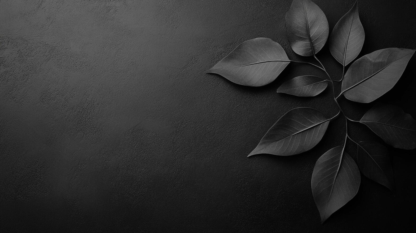 An artistic composition featuring delicate black leaves arranged on a dark textured background, evoking a sense of sophistication and understated elegance. photo