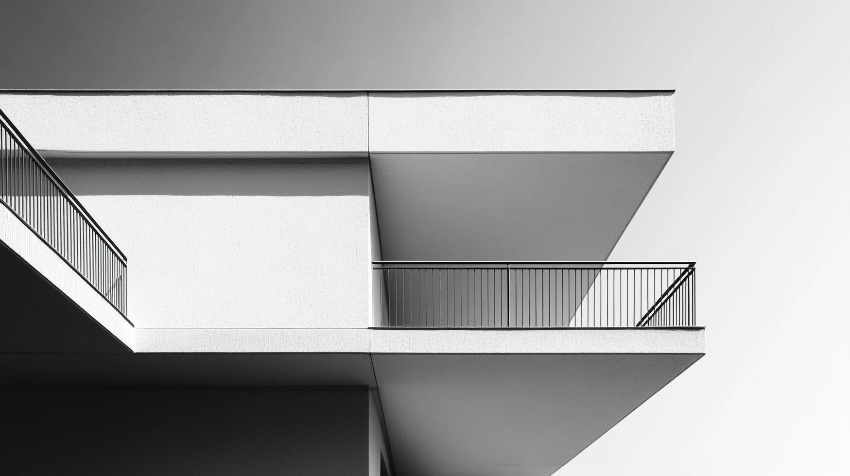 An abstract representation of architectural forms, showcasing overlapping structures and a clean, modern aesthetic against a gradient sky, emphasizing geometric shapes. photo