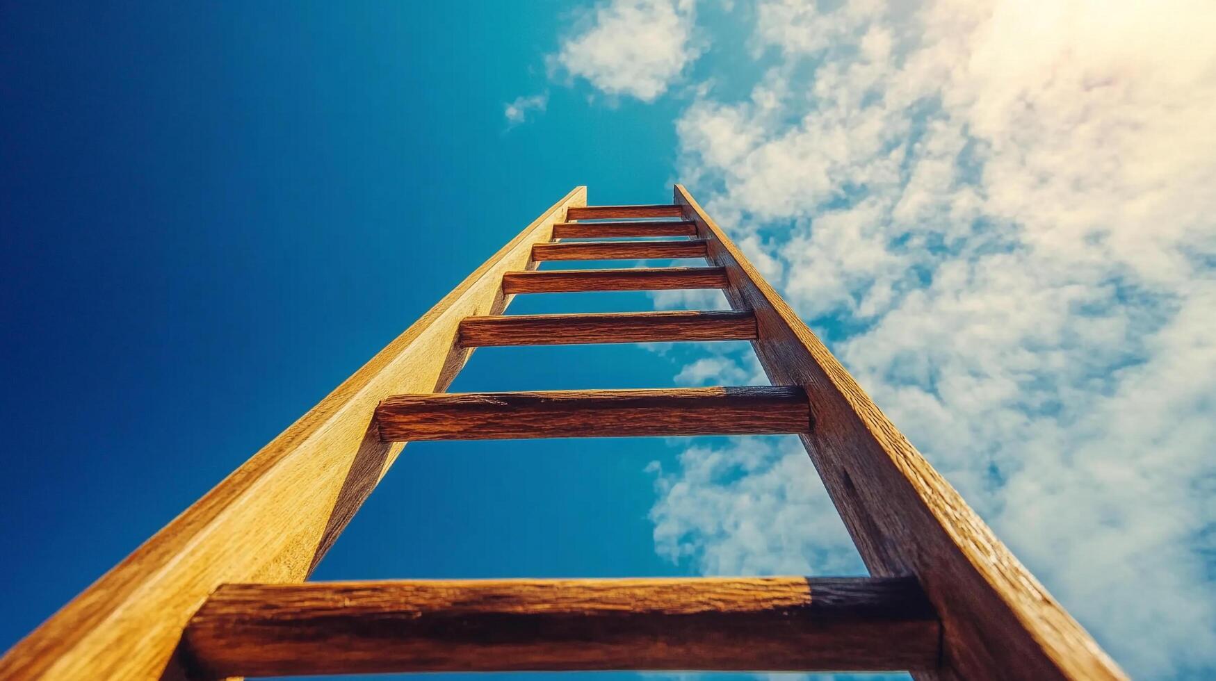 Ladder reaching up towards a bright blue sky with fluffy white clouds, symbolizing ambition, achievement, and reaching goals. photo
