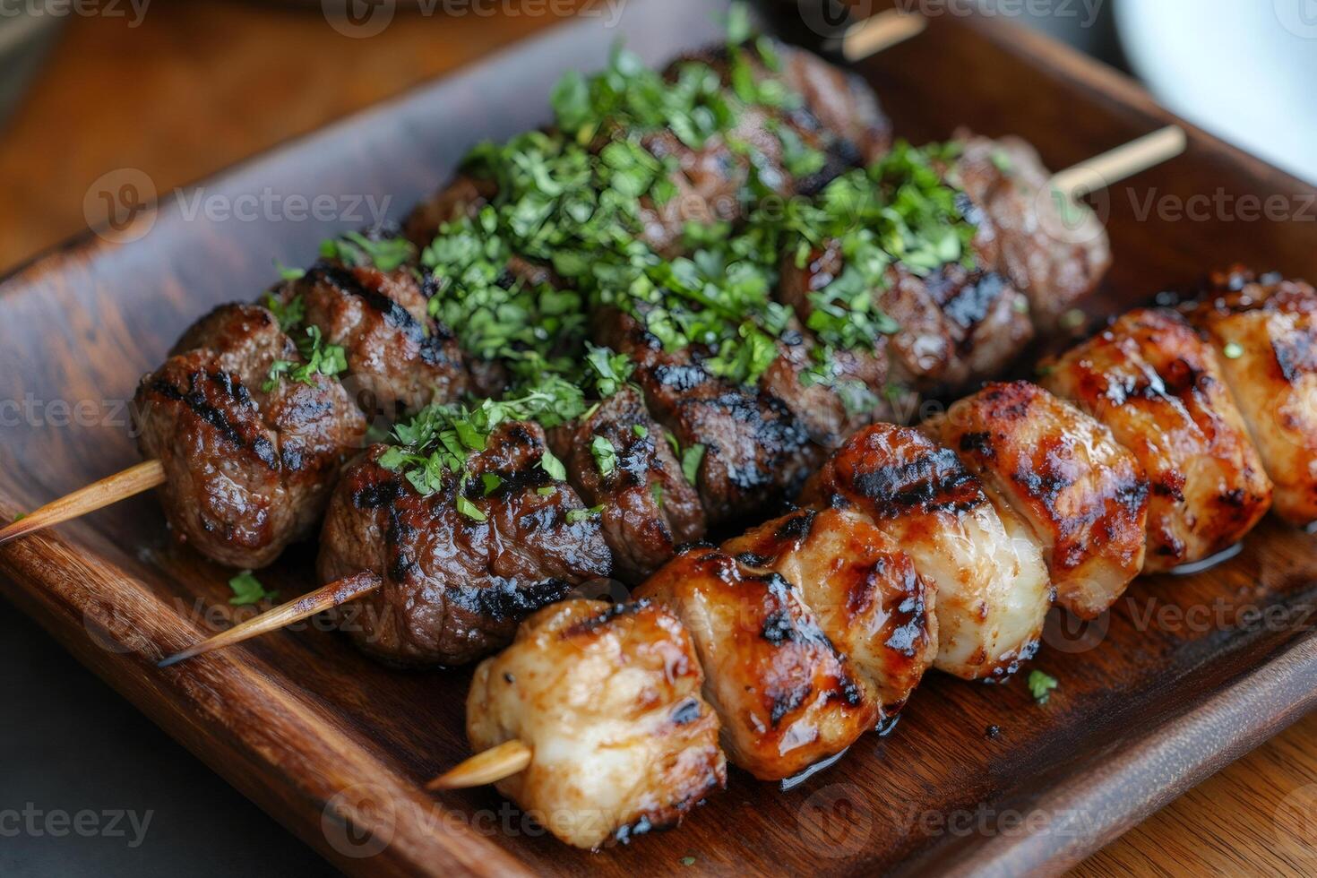 Grilled meat and chicken skewers garnished with parsley on wooden tray photo