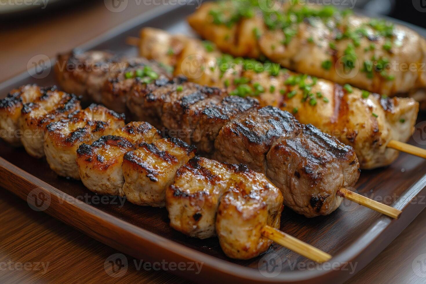 Mixed grill skewers with chicken, pork and beef grilling on wooden sticks photo
