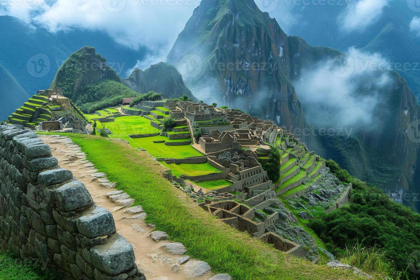 Machu Picchu revealing its majesty through clouds and lush vegetation photo