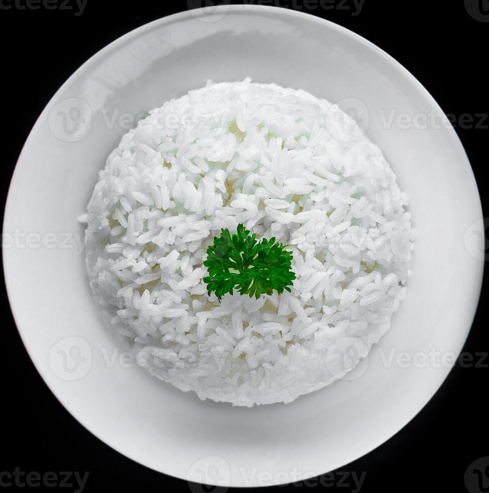 Plate with white rice serving for Vietnamese dish on black background photo