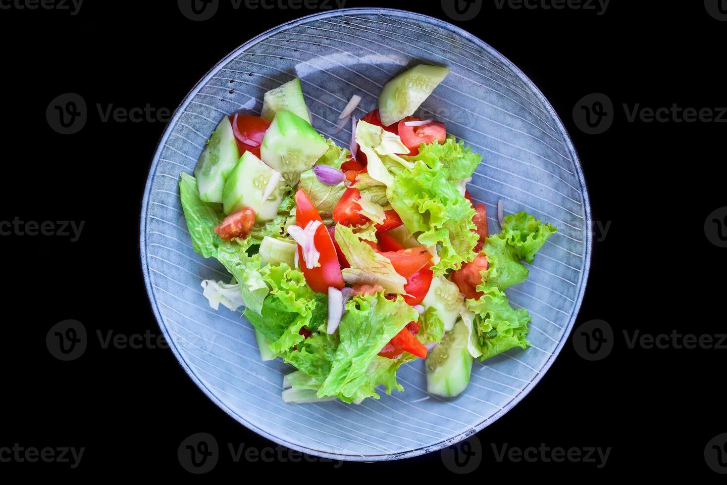 Fresh Vietnamese salad with vegetables on the black background side view photo
