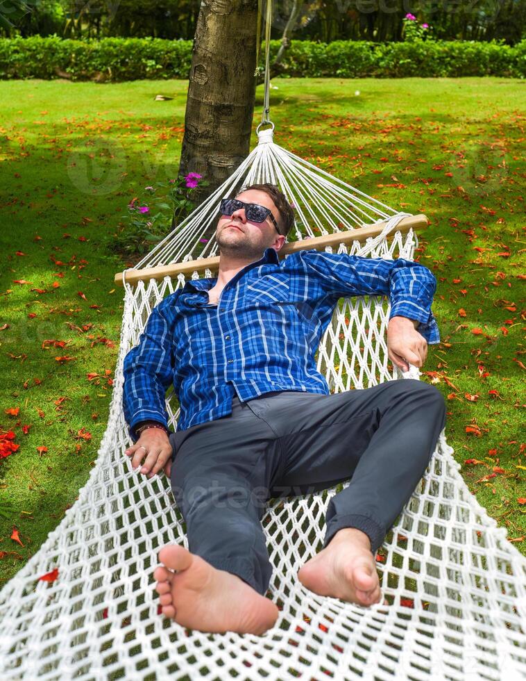 Young man freelancer resting on hammock photo