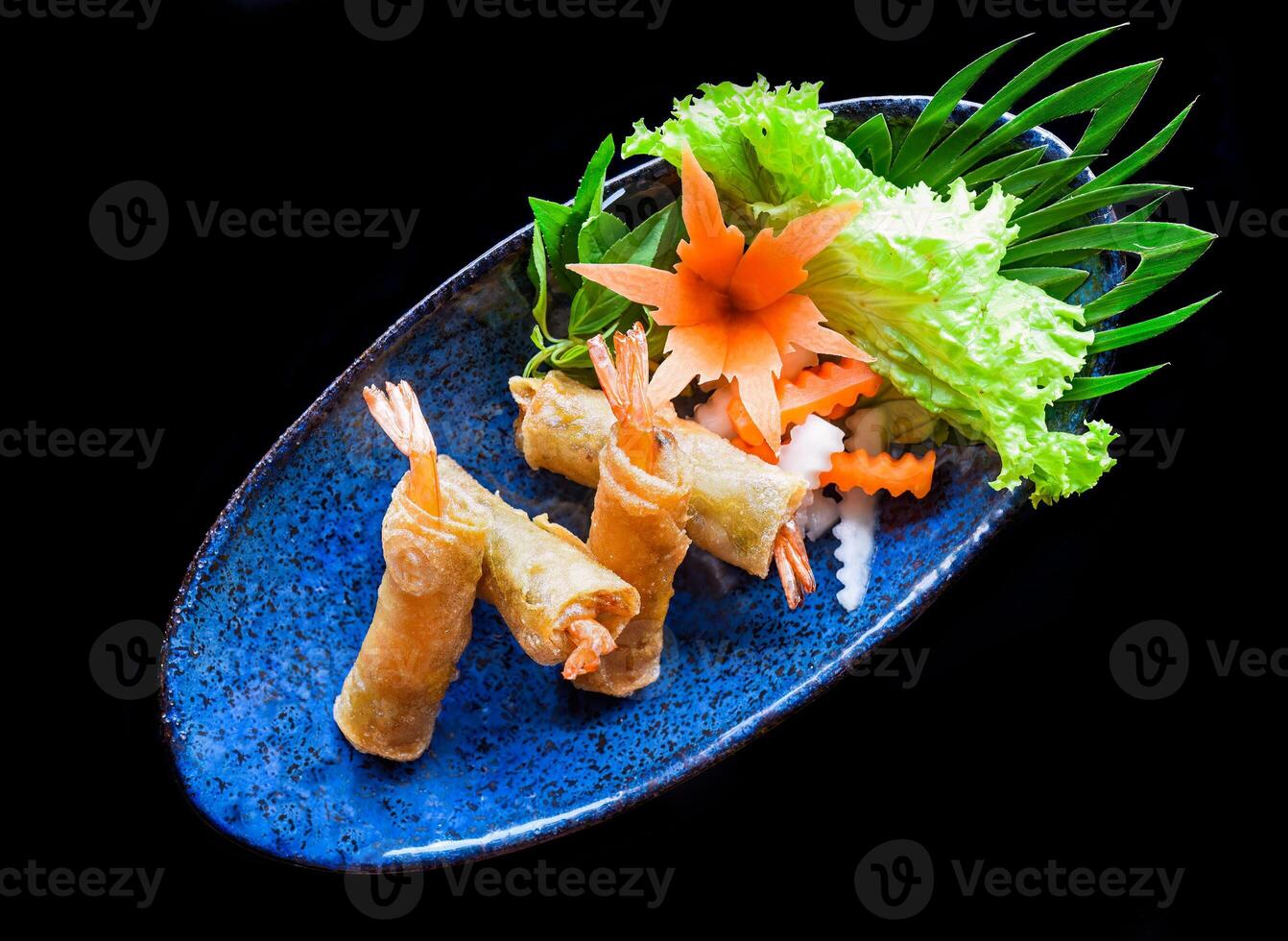 Traditional fried vietnamese spring rolls with shrimp and pork, rice paper on a black background photo