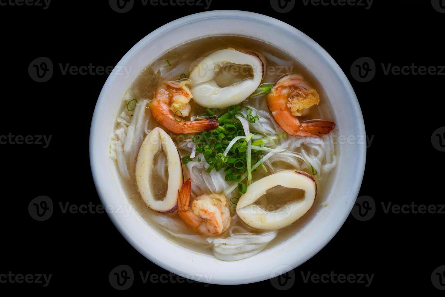 Traditional vietnamese soup Pho with seafood on black photo
