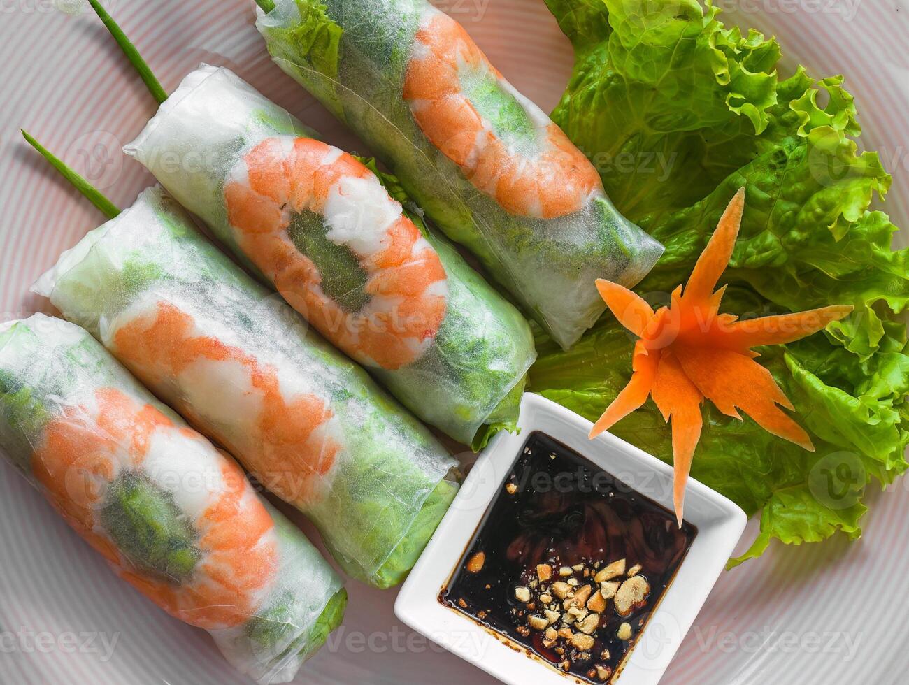 Traditional vietnamese spring rolls with shrimps rice paper on black background top view photo