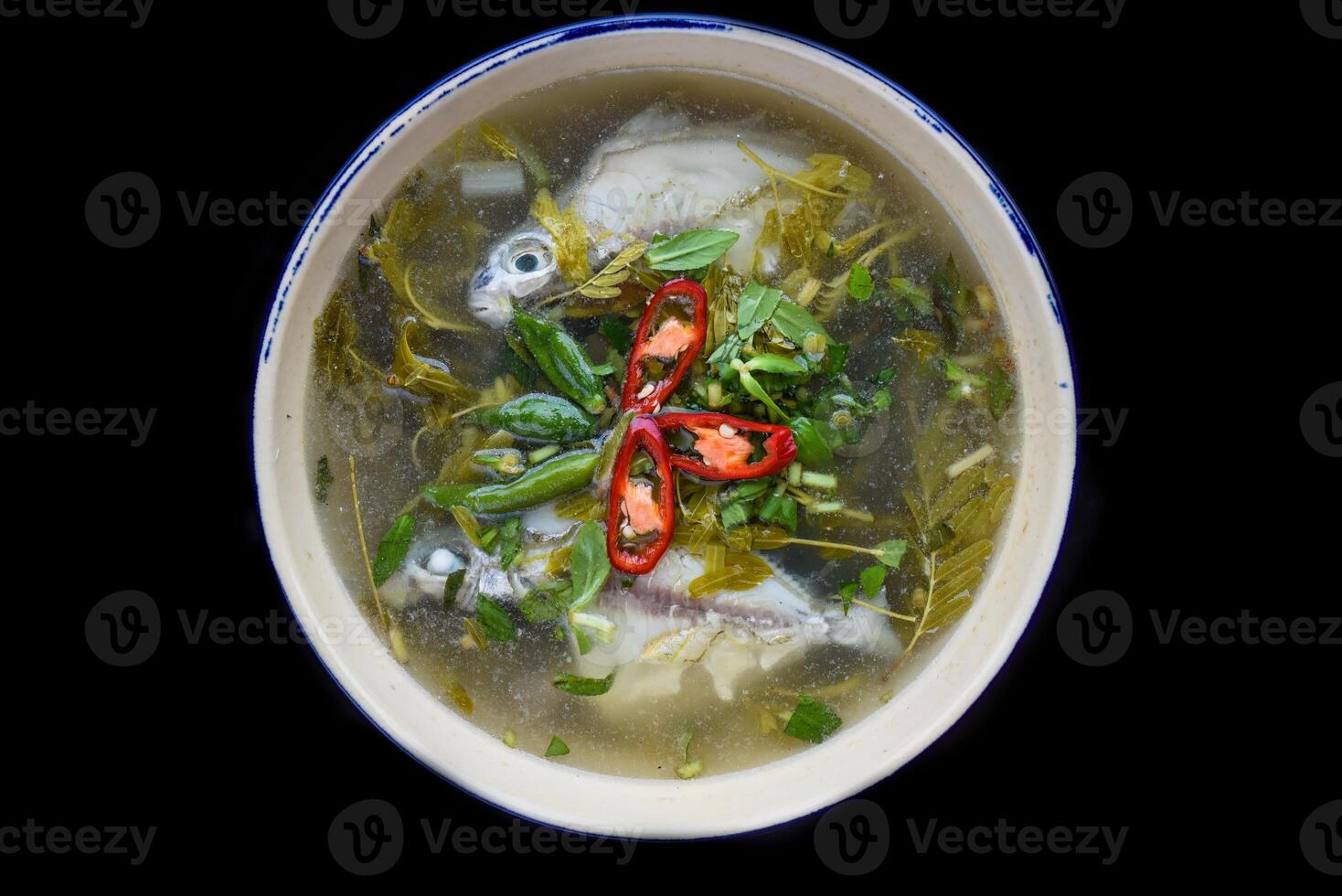 Canh Chua Ca or Vietnamese Sour Catfish Soup isolated on black background photo