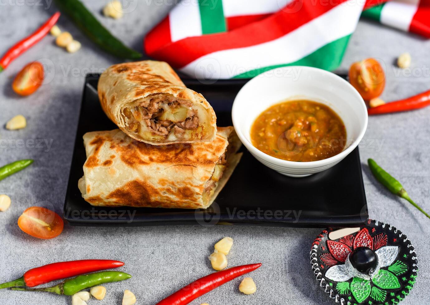 Mexican burrito with beef, french fries and cheese served with sauce borracha photo