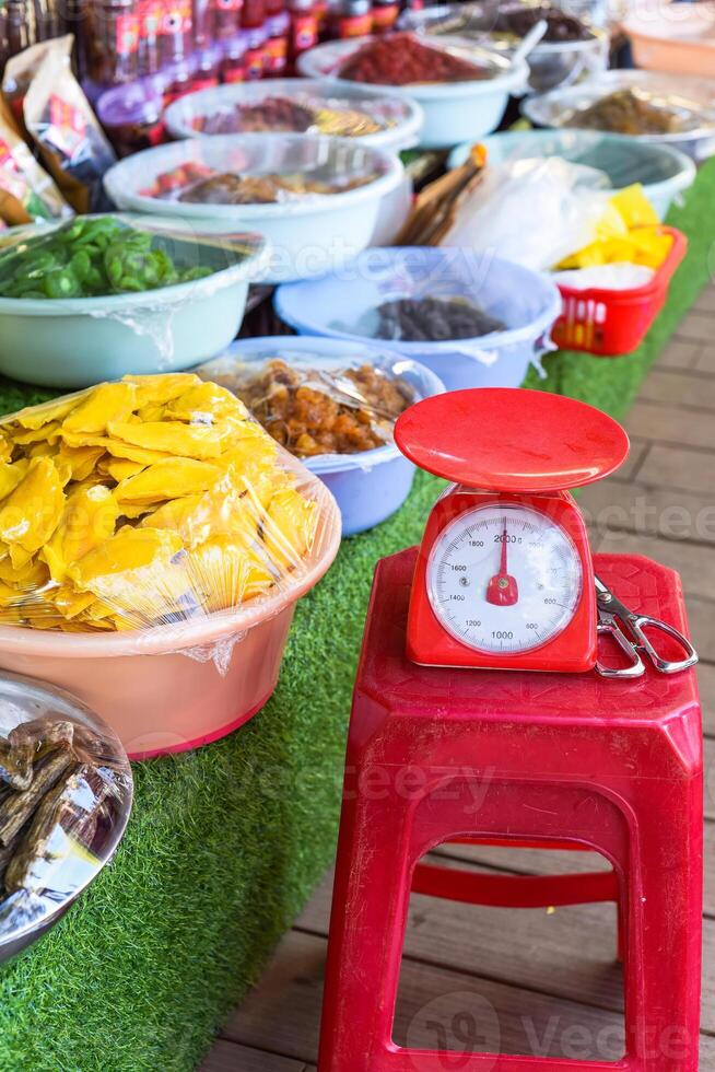 scales in the Vietnamese market for weighing dried fruits and snacks photo