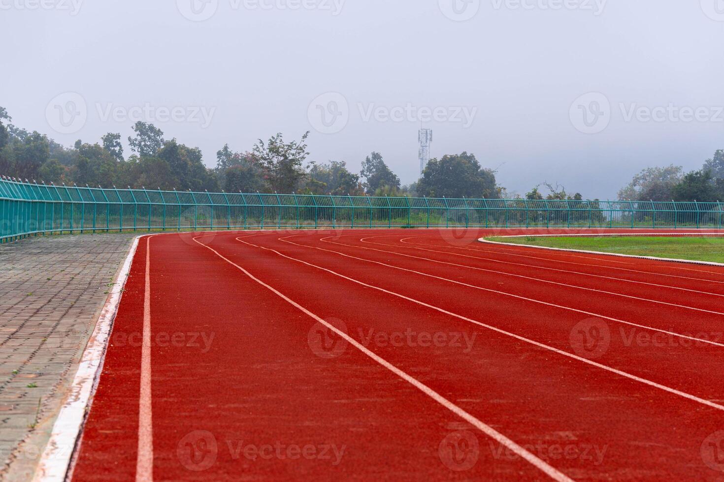 Empty running track in stadium Close up of athlete track or jogging track in university or college campus and building. photo