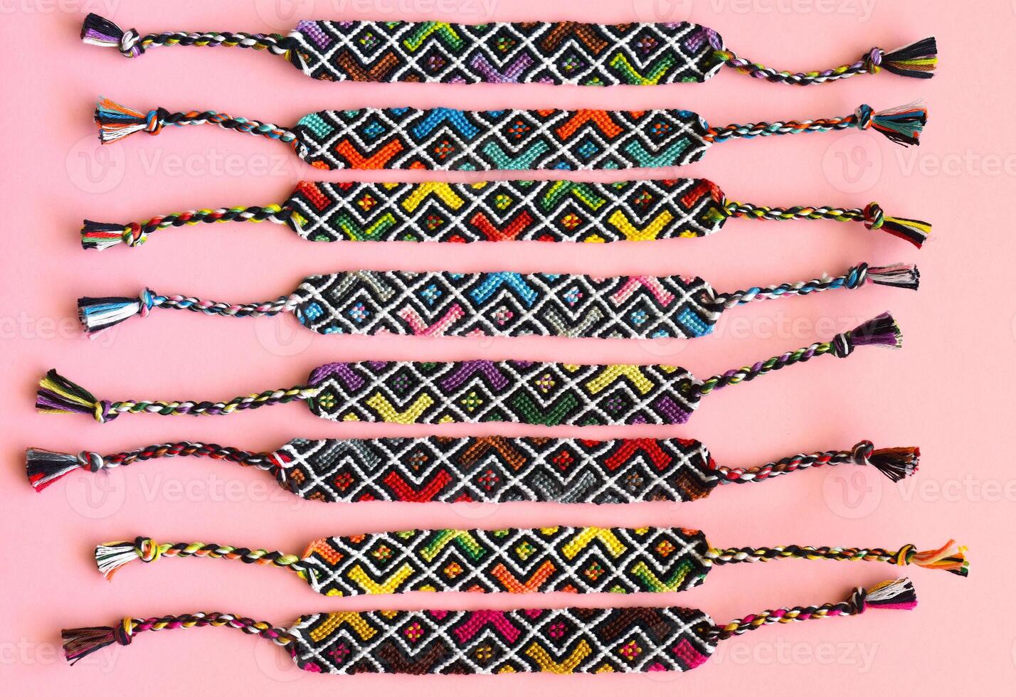 DIY woven friendship bracelets with abstract geometric pattern. Summer accessories photo