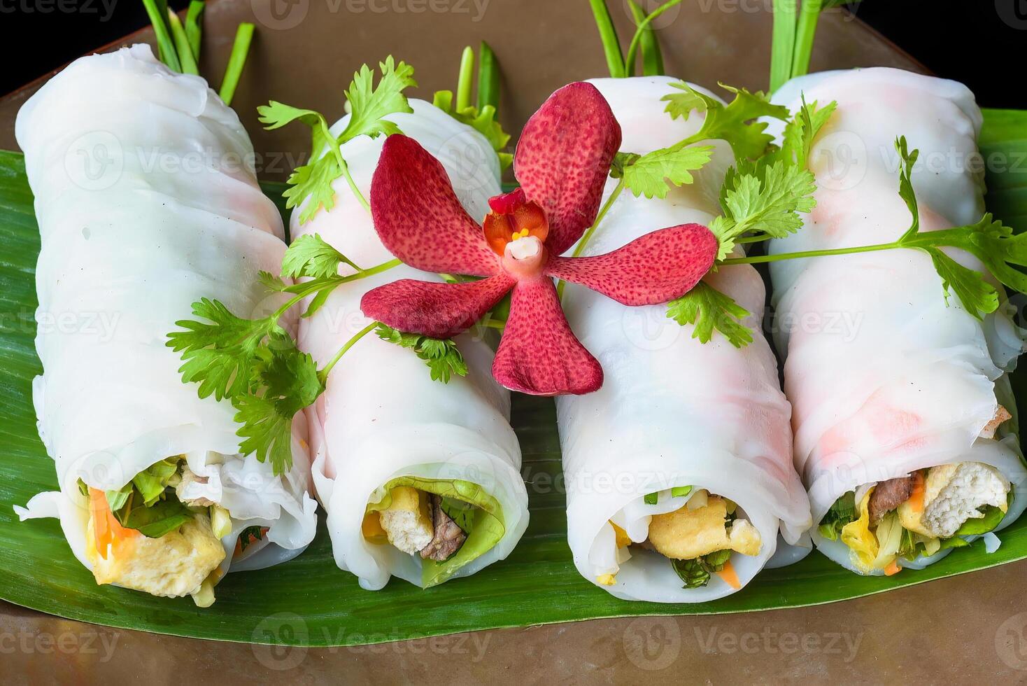 Vietnamese Pho spring roll with sea food tofu vegetables isolated on black background for a menu photo
