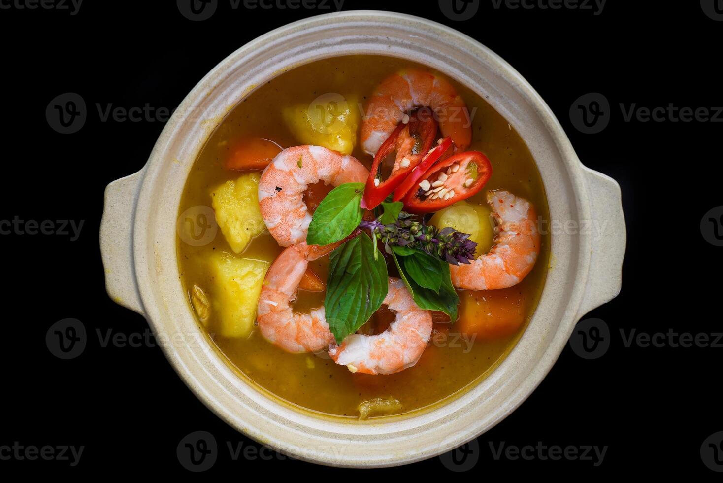 Stew with shrimps and pineapple isolated on black background top view photo