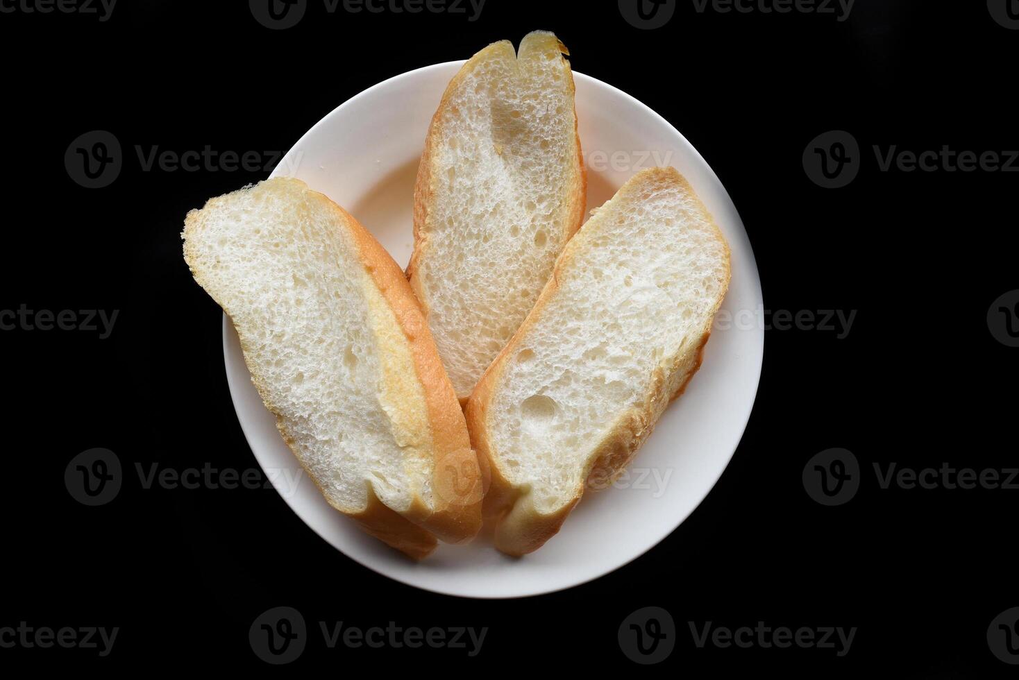 Sliced Vietnamese traditional Banh Mi baguette on a black background photo