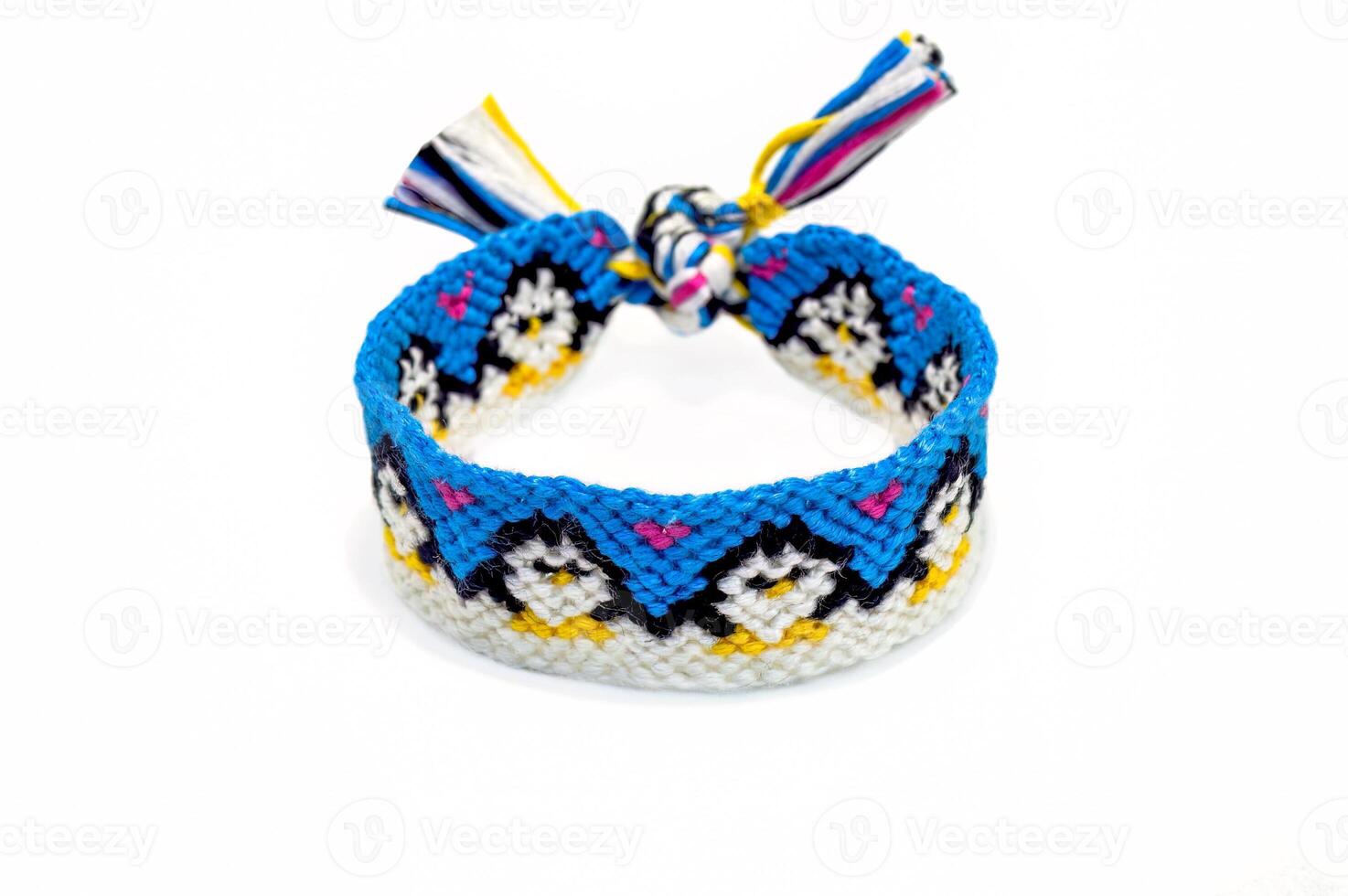 tied woven friendship bracelet with cute pattern Penguins hold their paws. Handmade of floss thread, isolated on white background. bracelet for women and children. photo