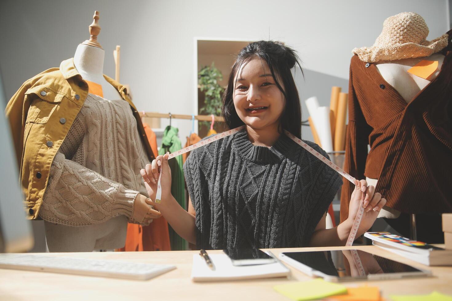 A woman is smiling while holding up a piece of fabric photo