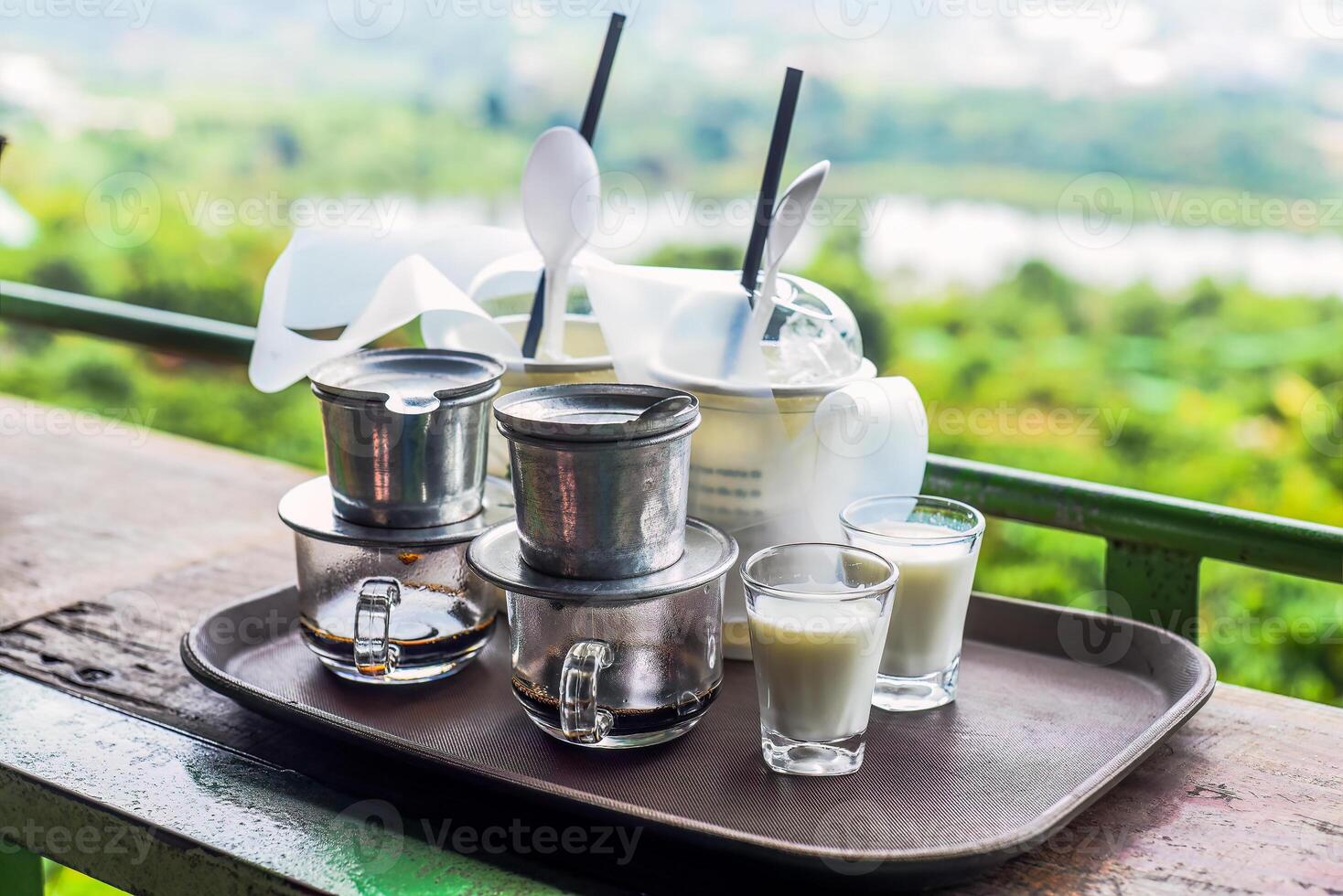 Vietnamese traditional coffee with milk on wooden table photo