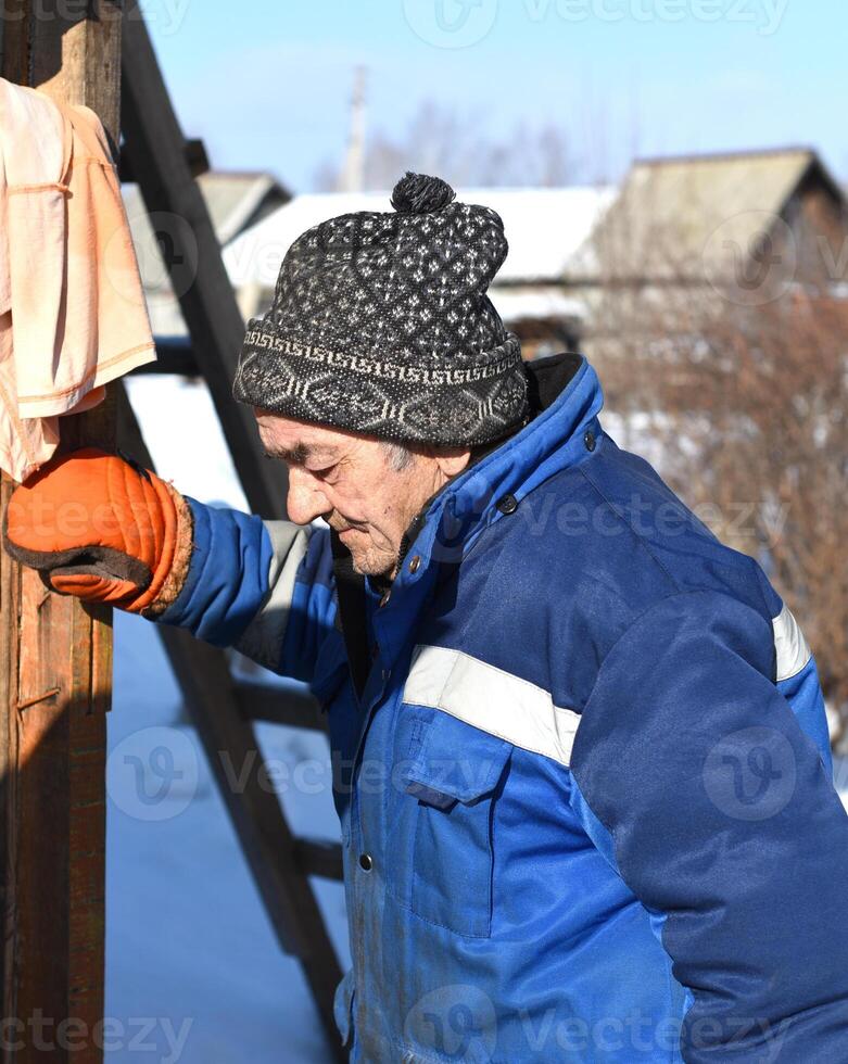 Portrait of old Russian man looking left, tired of work photo