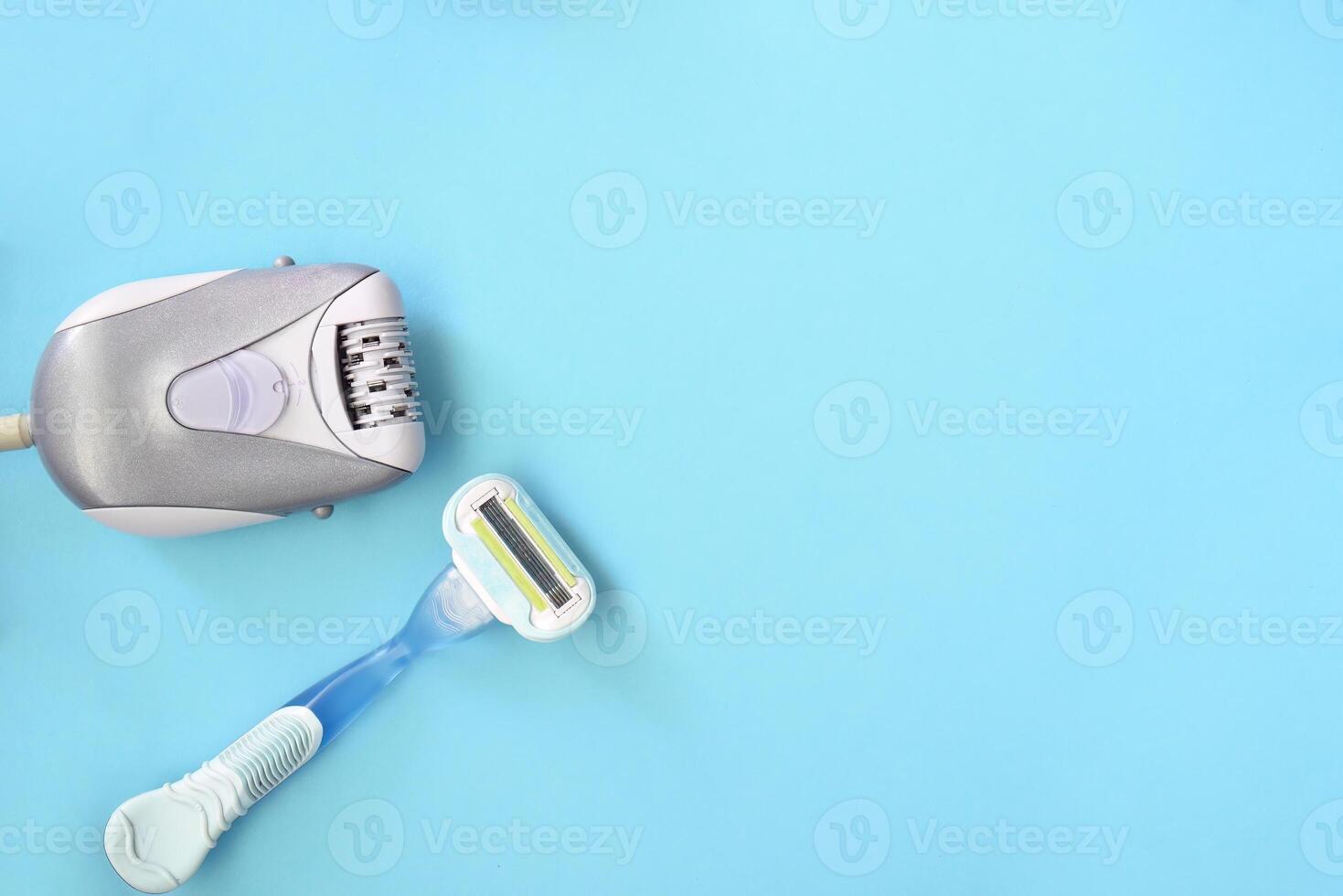 Epilator against razor on blue background. depilation methods for remove hair photo