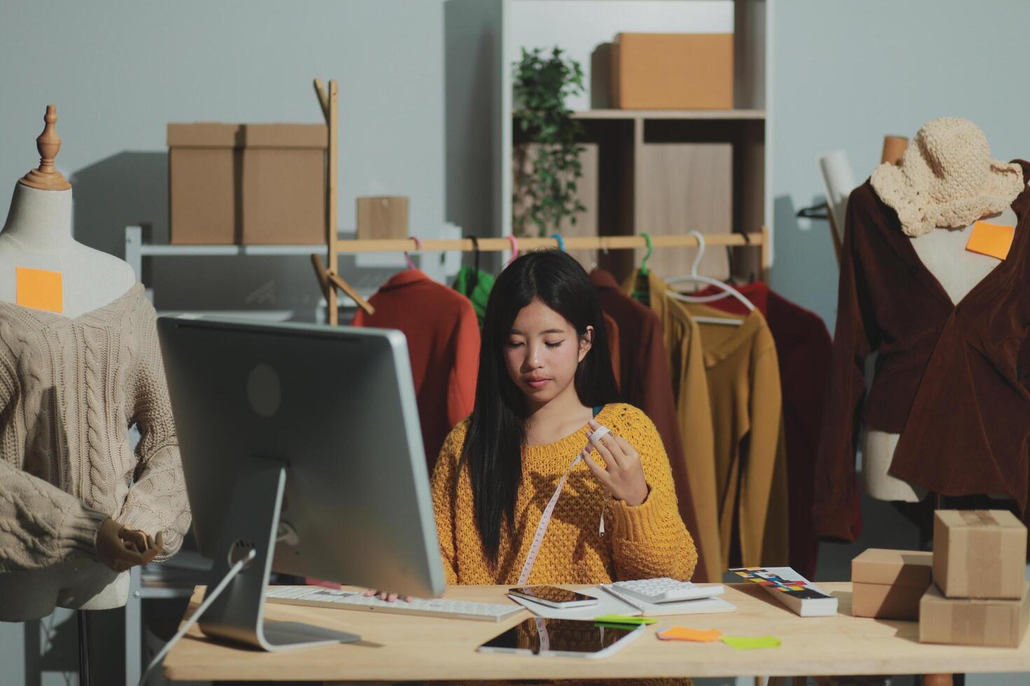 A woman is working on her computer in front of a desk photo