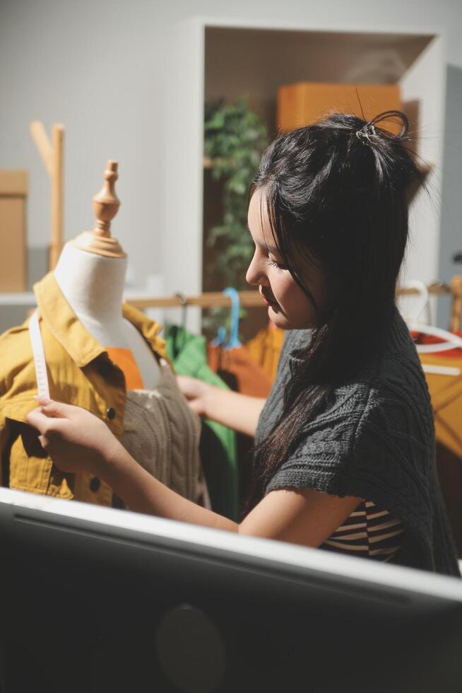 A woman is working on a computer in a room photo