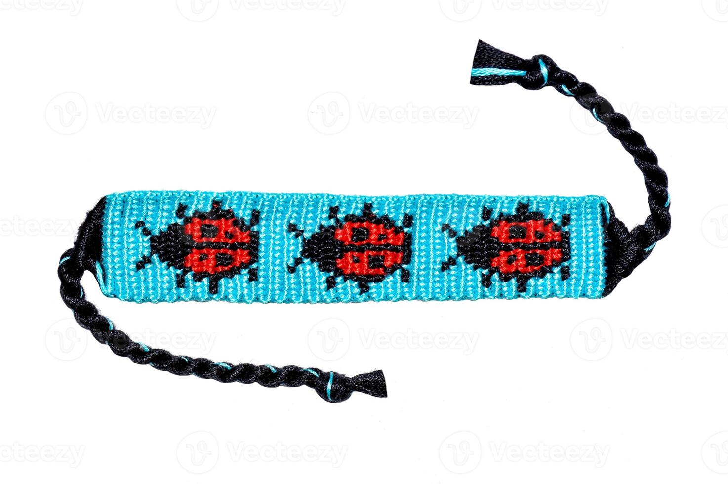 Tied woven DIY friendship bracelet with alpha pattern Ladybug handmade of embroidery bright thread with knots isolated on white background photo