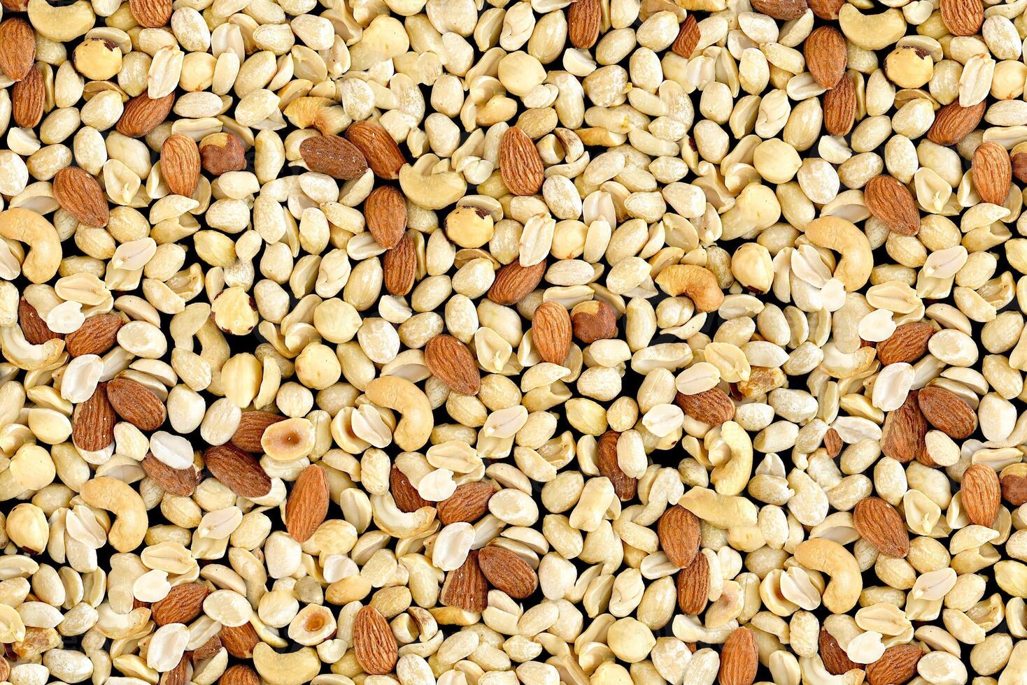 Pile of mixed nuts of almond, hazelnut, peanut and cashew photo
