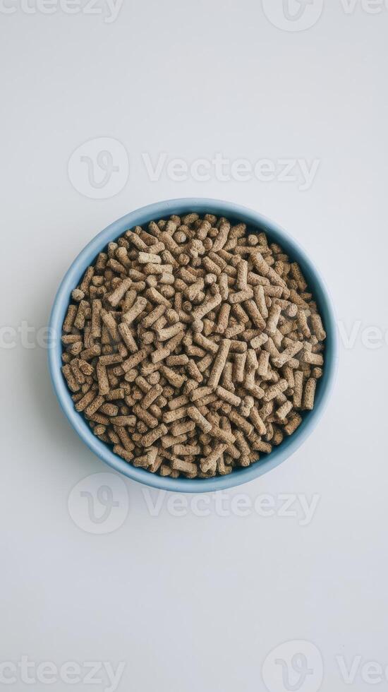 A bowl full of wood pellets on a white background photo