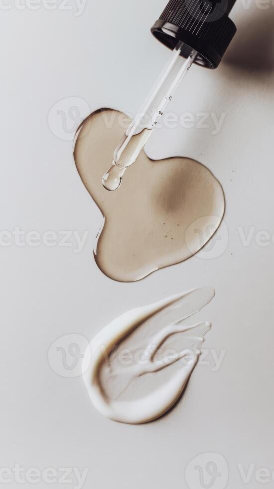 A bottle of cream being poured into a container photo