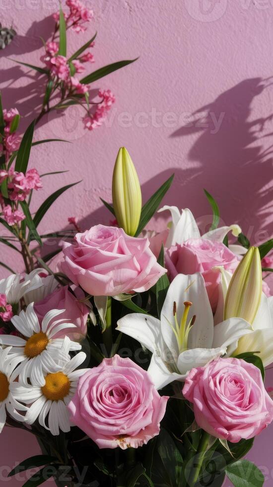 A vase of pink roses and white lilies photo