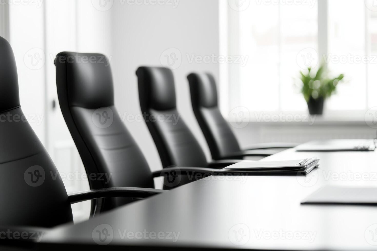 Conference room, Rows of empty black chairs face a table with files. Ready for a meeting photo