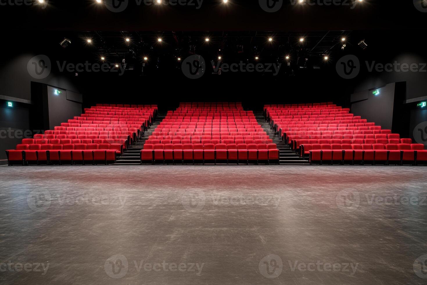 Empty stage with rows of unoccupied red seats in a theatre or auditorium ready for a show photo