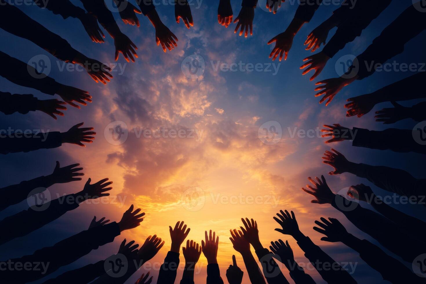 Silhouetted arms and hands reach towards a vibrant, colorful sunset, conveying unity and hope photo