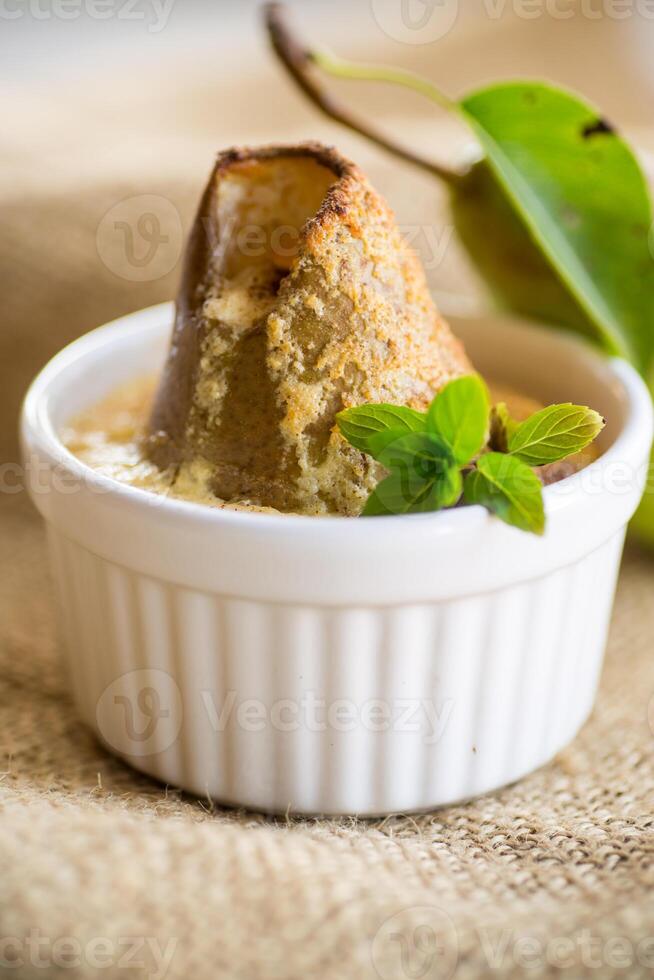 pear baked in curd dough in a small ceramic form photo