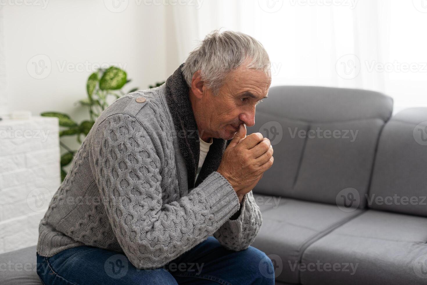 Portrait praying senior man against white background photo