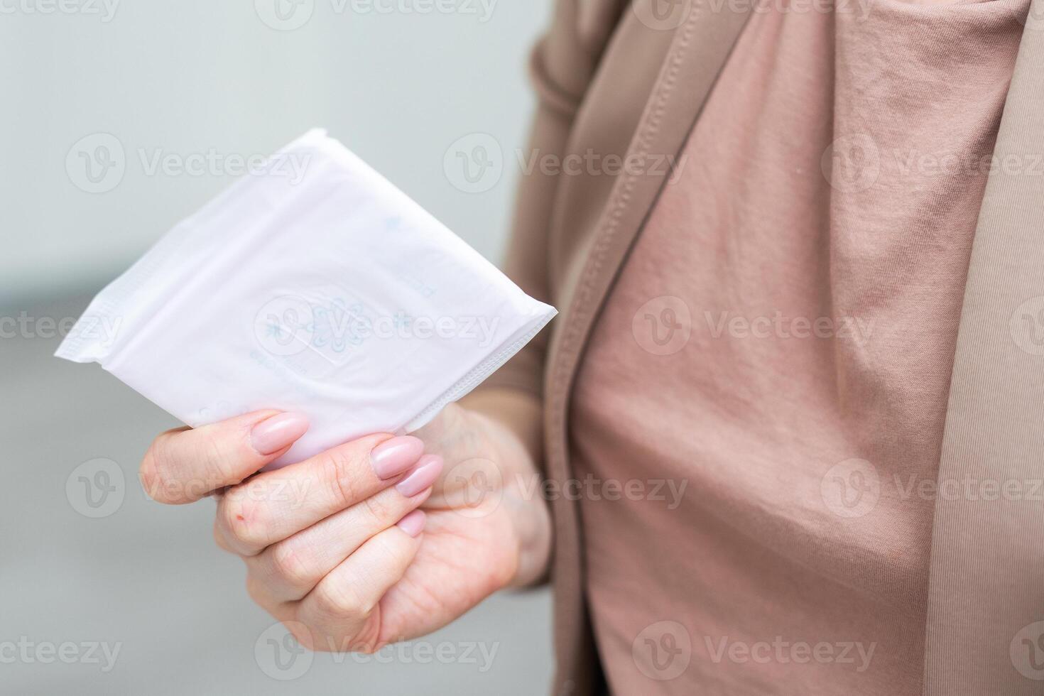 hand holding sanitary pad on white background photo