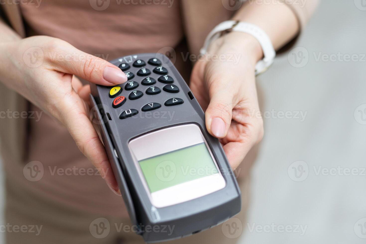 Woman holding modern payment terminal on white background, closeup photo