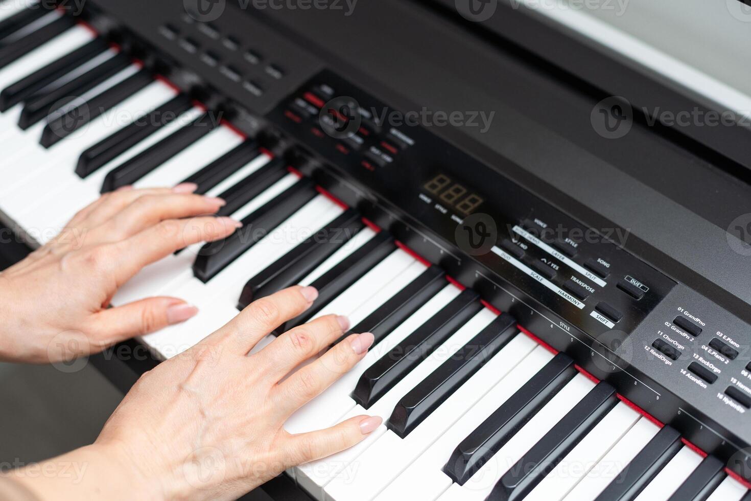 keyboard and hands playing the piano photo
