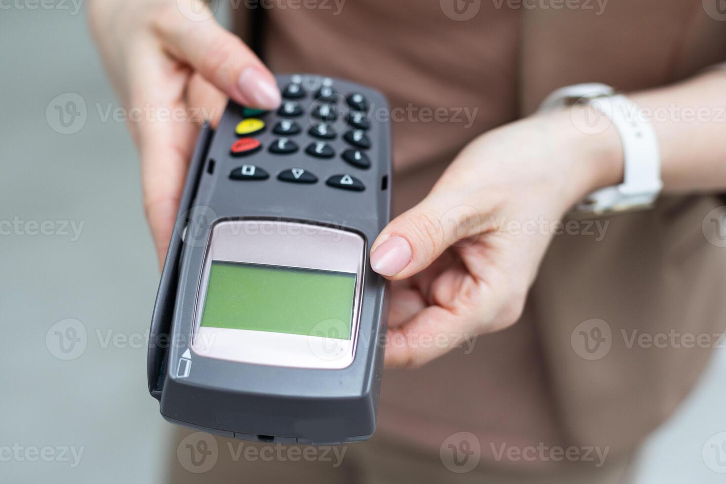 Woman holding modern payment terminal on white background, closeup photo