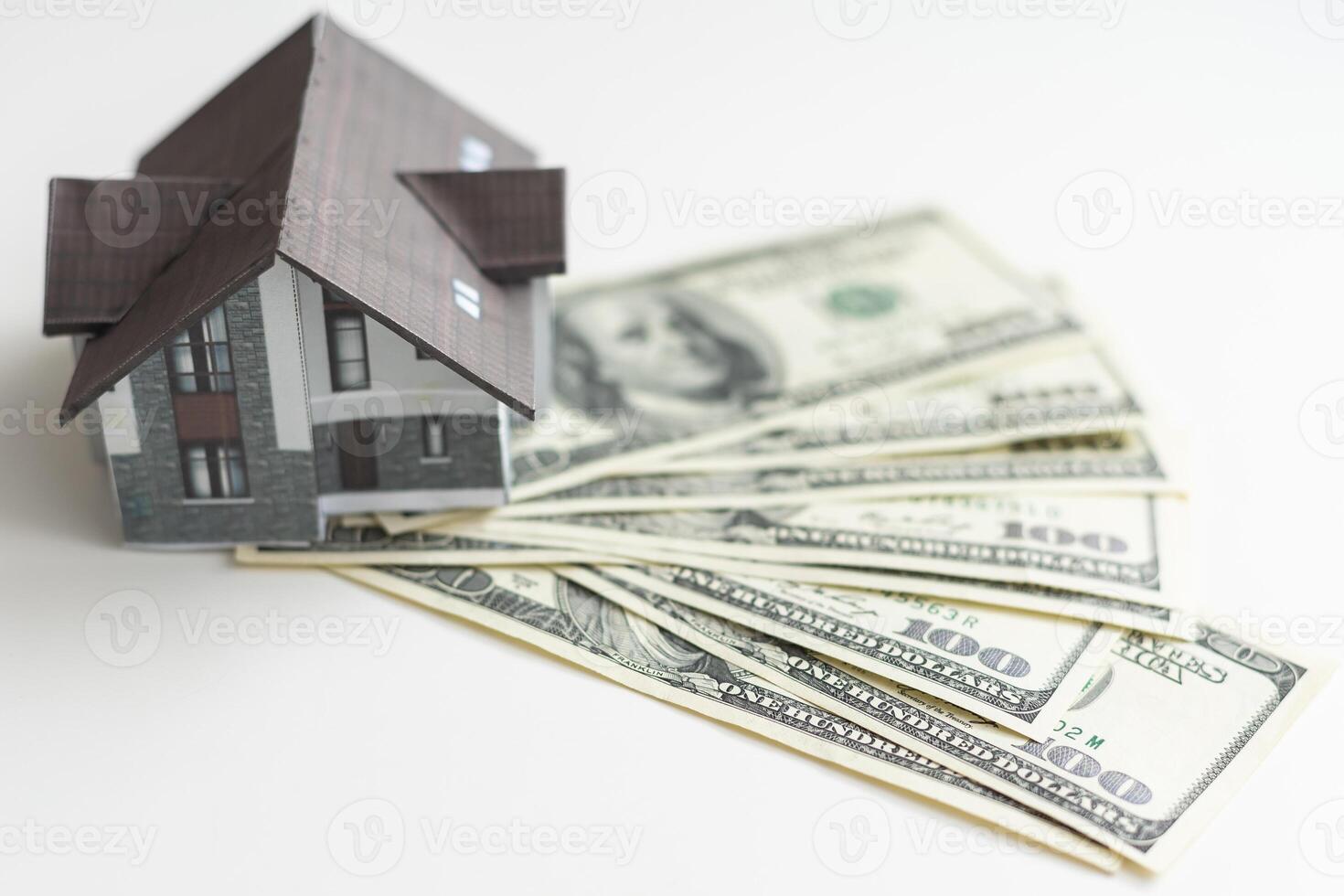 Small Model House on Layer of One Hundred Dollar Bills. photo