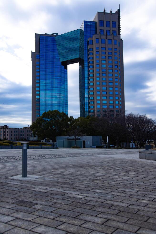 A cloud reflecting an impressive building cloudy wide shot photo