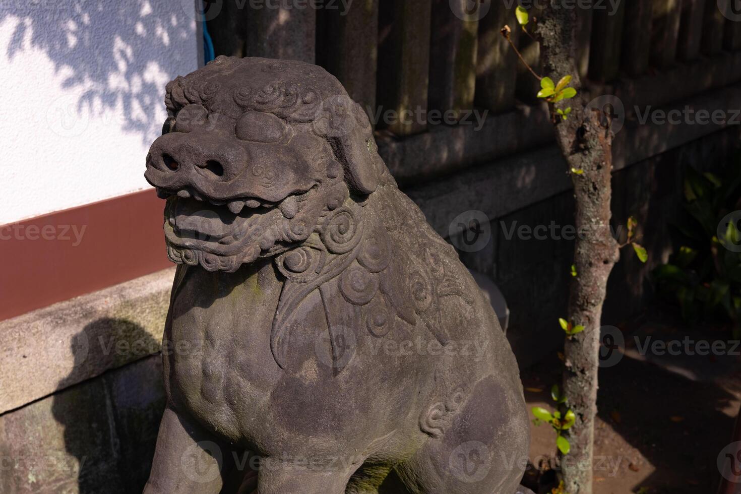 A guardian statue at Tomioka Shrine with copyspace photo